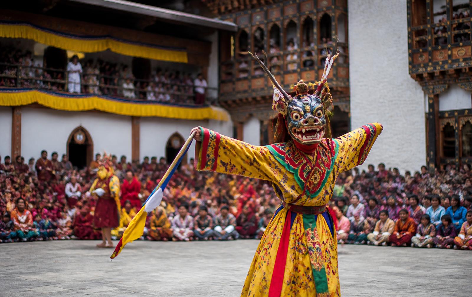 Masked dancer performing at a Bhutanese festival